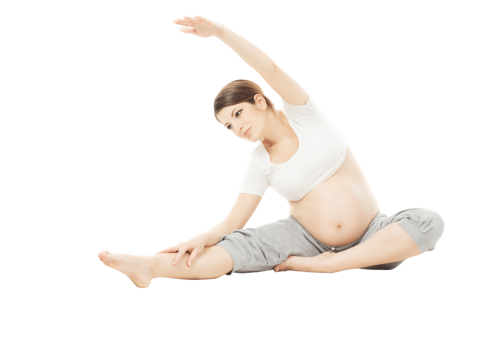 Pregnant woman with husband expecting baby with yoga pose at ocean